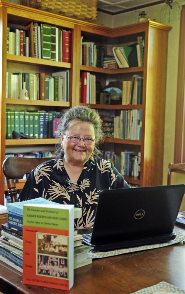 Dale Potter-Clark poses for a portrait Wednesday with her recently published book at her Vassalboro home.