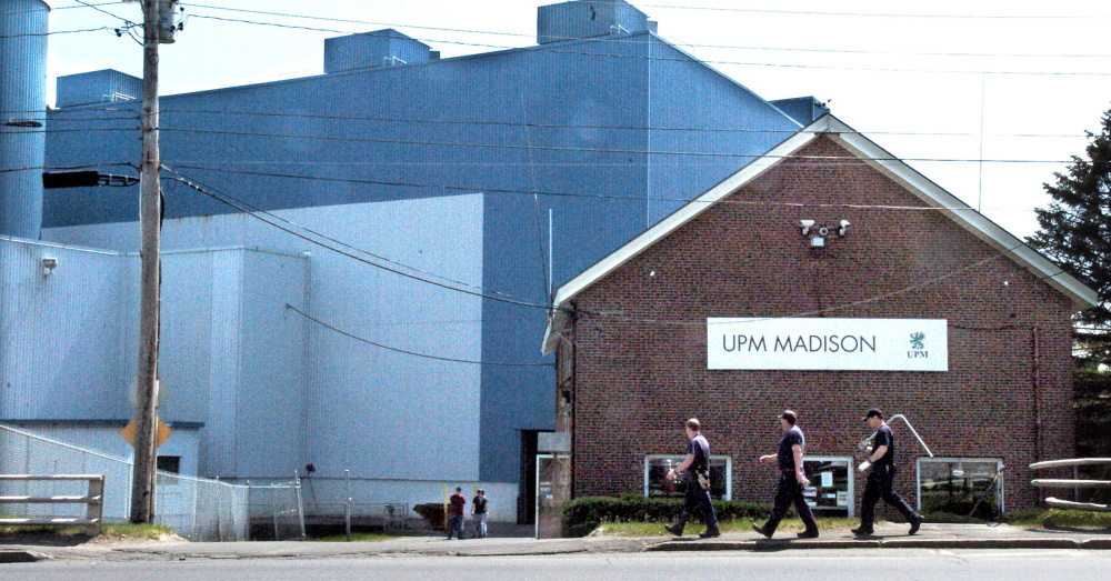 Mill workers carry tools into the Madison Paper Industries mill in Madison on May 23. The mill's closure, announced in mid-March, has impacted the town's tax rate,