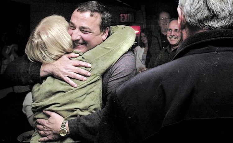 Paul LePage gets a hug from a supporter in November 2003 after he was elected mayor of Waterville. LePage served until 2010, when he was elected Maine governor.