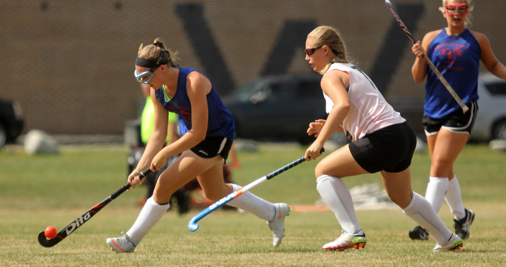 Messalonskee High School's Autumn Littlefield moves the ball the past Gardiner Area High School's Jazmin Cleary during a field hockey scrimmage in Winslow on Saturday.