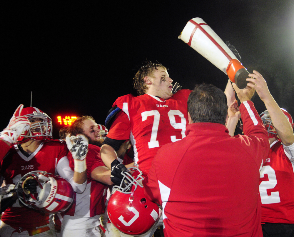 Staff file photo by Joe Phelan 
 Elijah Tobey and fellow Cony teammates celebrate with the boot after they sank Gardiner in the annual rivalry game last season.