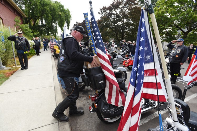 Patriot Guard Riders salute as the cremated remains of Maine Civil War soldier Jewett Williams are packed on a motorcycle following a ceremony Monday at Oregon State Hospital in Salem, Ore.
