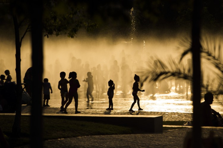 Children play as they cool down in a fountain beside the Manzanares river in Madrid, Spain, in 2015. Earth's fever got worse last year, 450 international scientists diagnosed in a massive report nicknamed the annual physical for the planet.