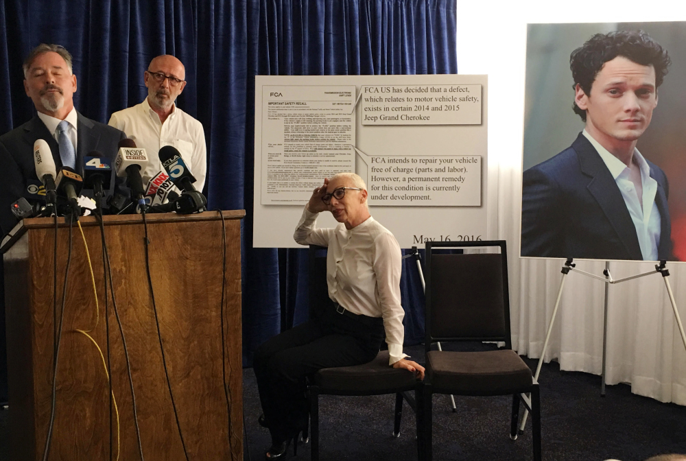 Attorney Gary Dordick, left, representing Victor and Irina Yelchin, parents of the late actor Anton Yelchin, talks to the media after filing a wrongful-death and product-liability lawsuit against Fiat Chrysler in Los Angeles Superior Court on Tuesday. Anton Yelchin, whose photo is posted at right, was crushed by his Jeep when it rolled backward down the driveway of his Los Angeles home June 19.