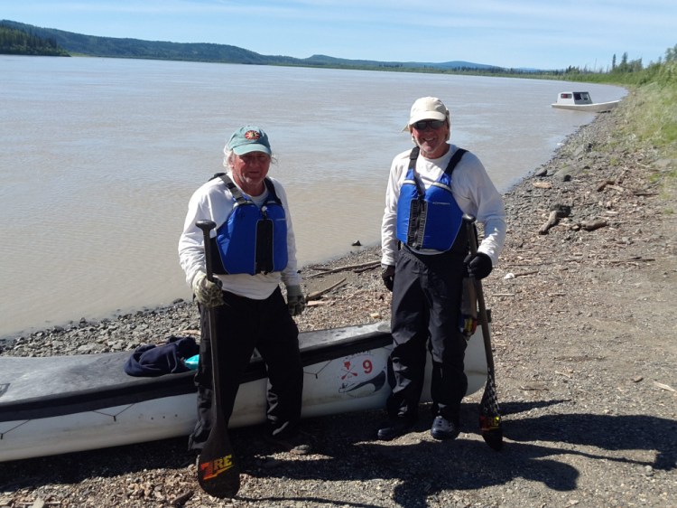 Terry Wescott, left, of Thorndike and Brad Krog, right, of Bowdoin stand ashore beside the Yukon River near Fairbanks, Alaska, after finishing the Yukon 1000 and becoming the first canoe team, as well as the oldest team, to win the endurance wilderness race.