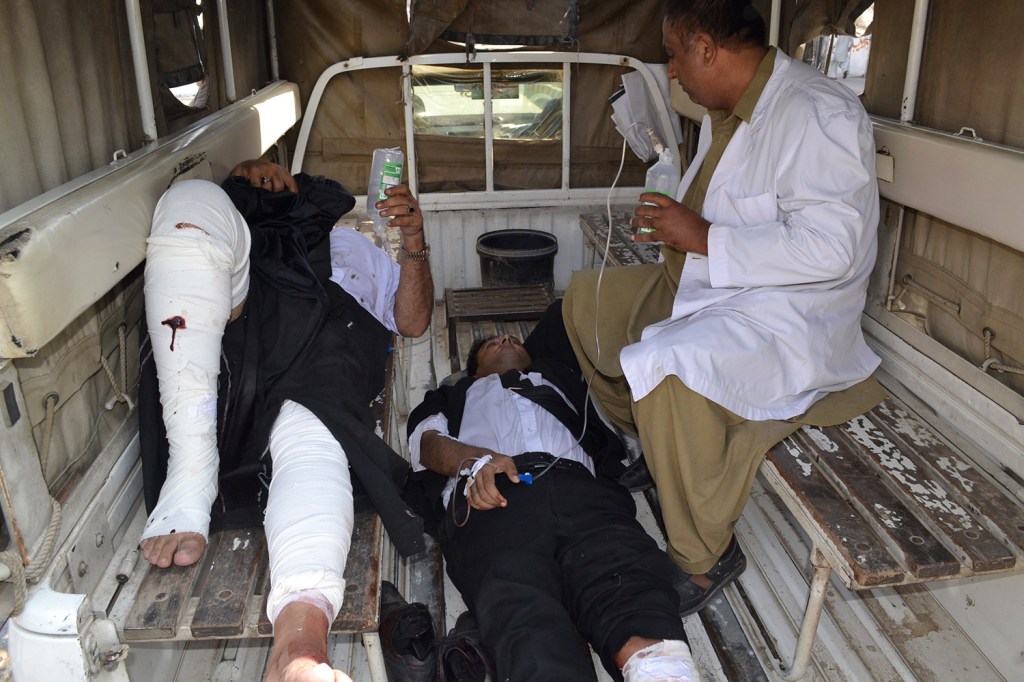 A Pakistani paramedic accompanies injured lawyers to a hospital following a bomb blast in Quetta, Pakistan. Associated Press/Arshad Butt