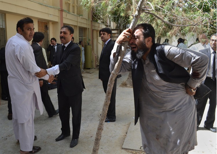 Pakistani lawyers mourn the deaths of their colleagues following a bomb blast. A powerful bomb went off inside a government-run hospital in the southwestern city of Quetta on Monday, killing dozens of people and wounding dozens of others, police said. Associated Press/Arshad Butt
