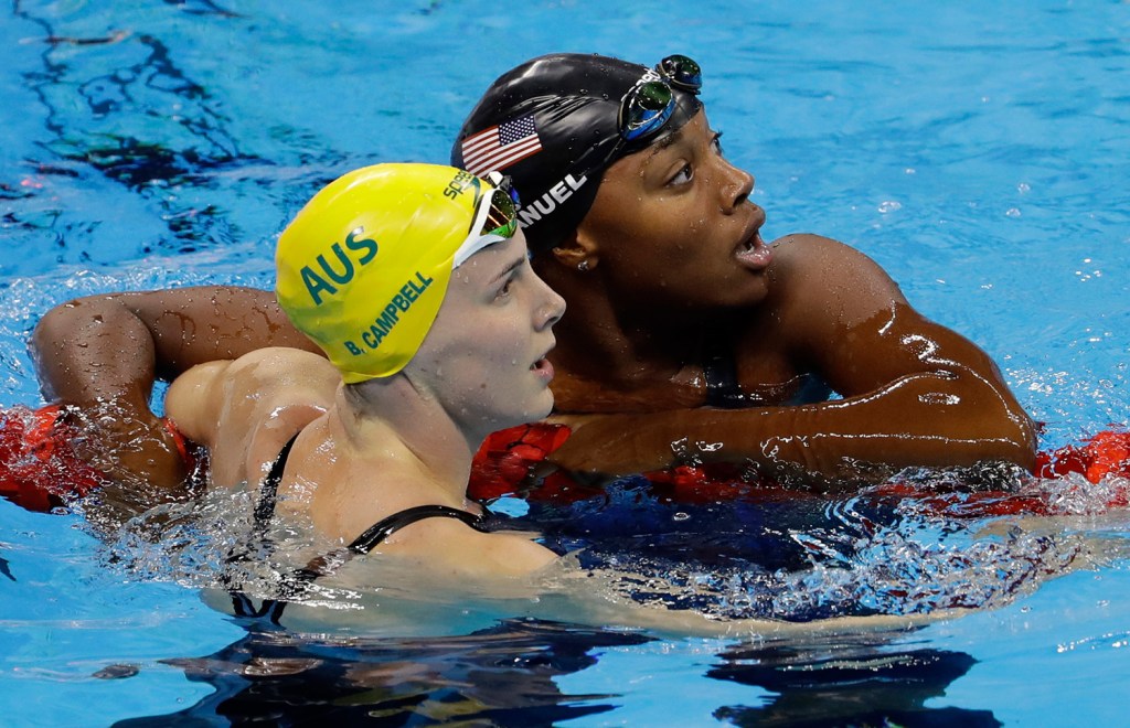 Simone Manuel, right, looks at the scoreboard with Australia's Bronte Campbell after Manuel set a new Olympic record in the women's 100-meter freestyle in Rio de Janeiro, Brazil.
