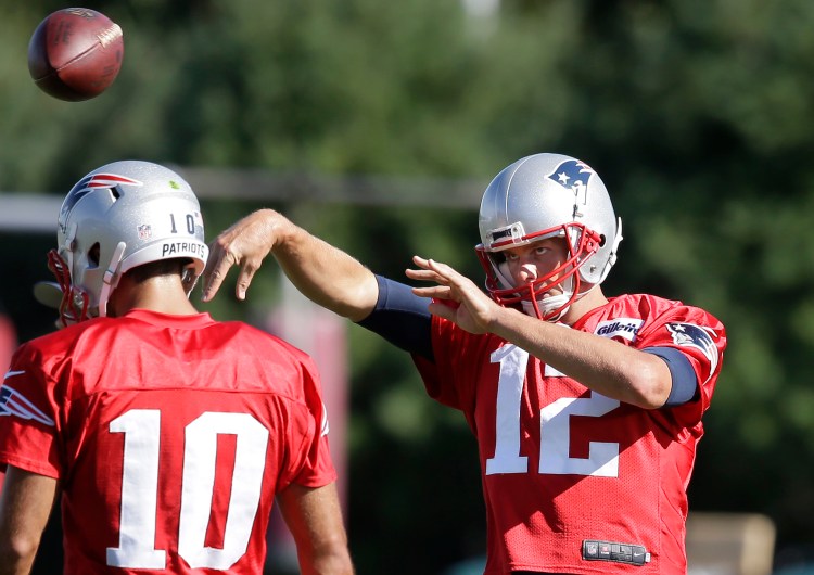 New England quarterback Tom Brady throws past Jimmy Garoppolo, who will lead the team for its first four games.    Associated Press/Steven Senne