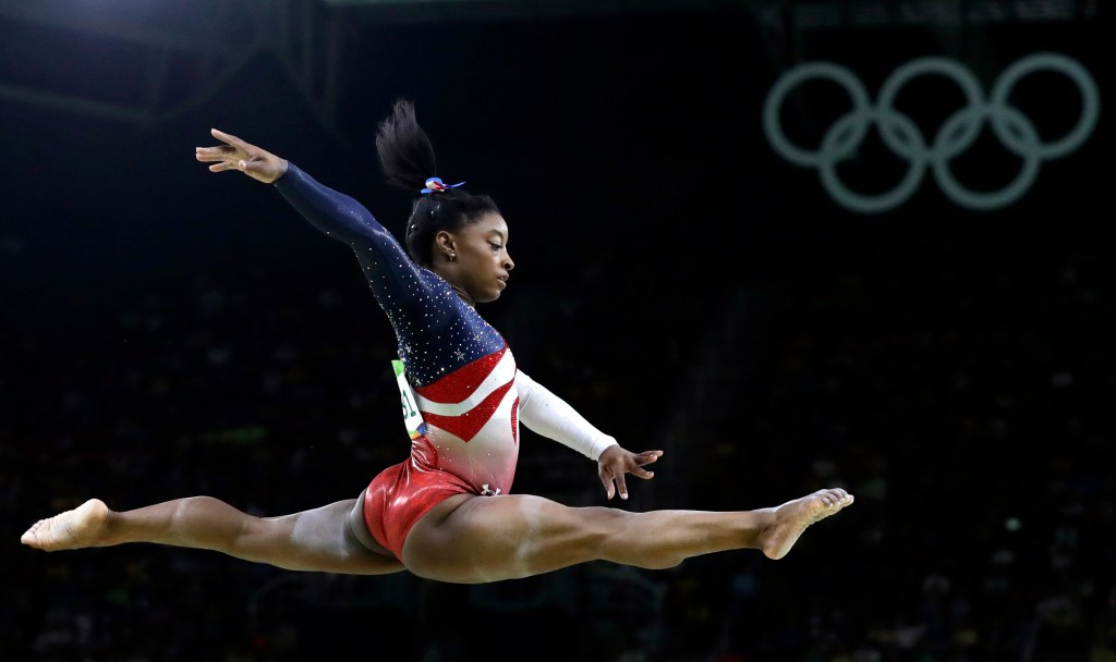 Simone Biles performs on the balance beam during the gymnastics women's team final.    Associated Press/Rebecca Blackwell
