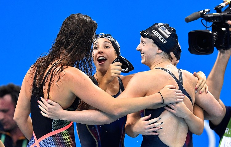 Katie Ledecky, right, celebrates with her U.S. teammates Allison Schmitt, Maya DiRado and Leah Smith, from left, after they won the 4 x 200-meter freestyle relay Wednesday night. Ledecky picked up her third gold medal of the Rio Games.
Associated Press/Martin Meissner