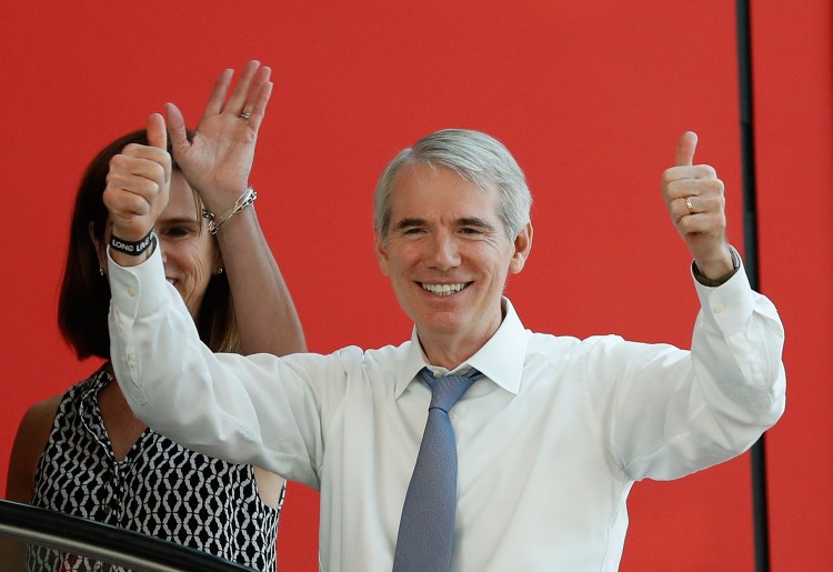 Sen. Rob Portman, R-Ohio, and his wife arrive at the The Rock and Roll Hall of Fame and Museum in Cleveland, in July during the second day of the Republican convention. Portman is betting that a significant number of Ohioans will divide their preferences between the two parties as they work their way down the ballot.