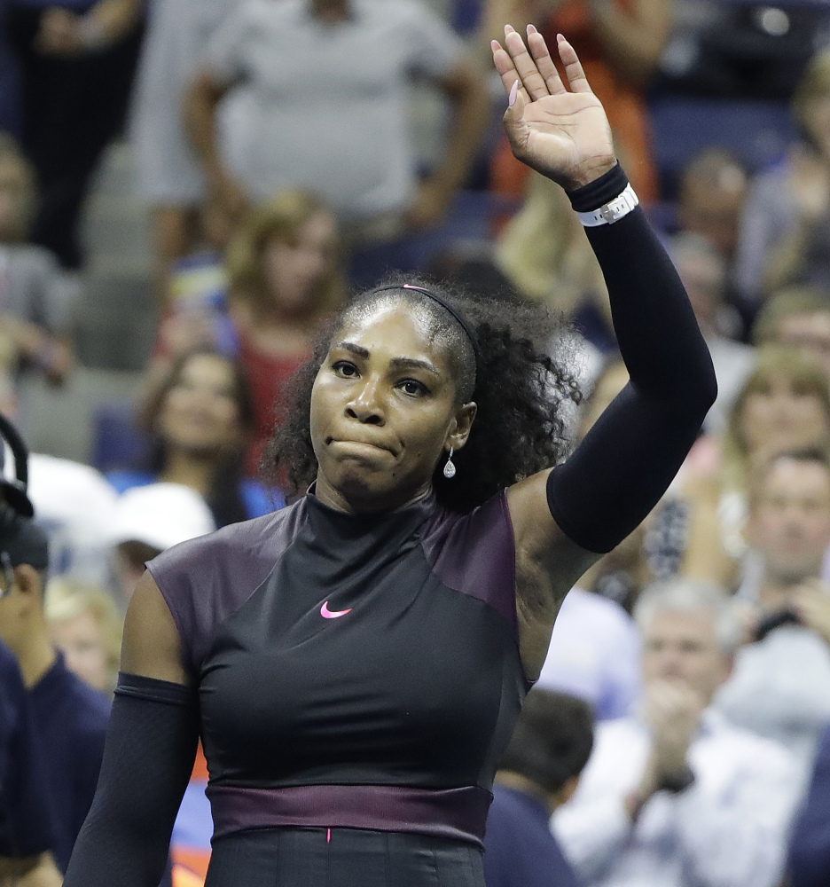 Serena Williams waves to the crowd – one that included Beyonce and Jay Z – after defeating Vania King in the second round of the U.S. Open at Arthur Ashe Stadium in New York.