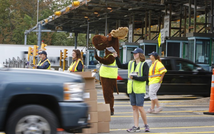 Drivers going south on the Maine Turnpike on Monday morning are greeted at the York toll plaza by Miles the Moose and Claudette the Lobster, along with turnpike authority employees who handed out copies of the 2017 Farmers' Almanac.
Jill Brady/Staff Photographer