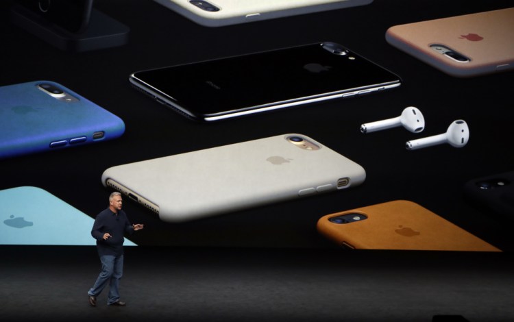 Phil Schiller, a vice president for Apple, discusses Apple's new Airpods, at right, which allow users to receive audio wirelessly.