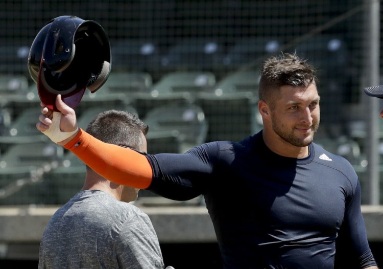Former NFL quarterback Tim Tebow finishes a workout for baseball scouts and the media in Los Angeles. Tebow signed a minor league contract with the New York Mets Thursday.