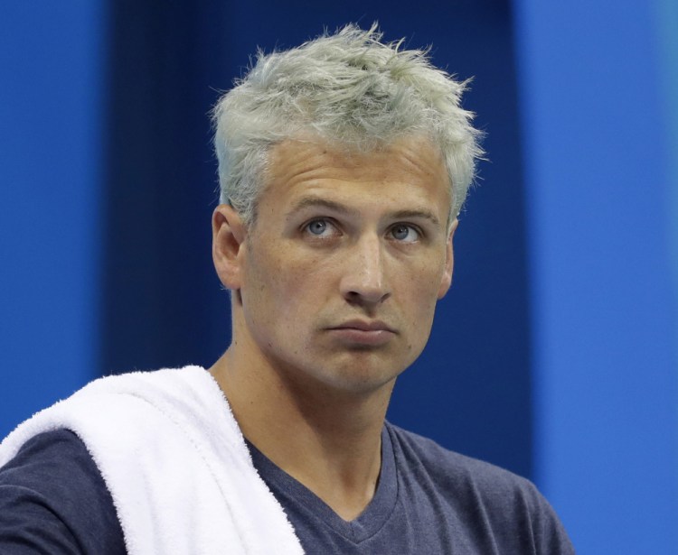 Associated Press/Michael Sohn, File
Ryan Lochte prepares before a men's 4x200-meter freestyle heat at the 2016 Summer Olympics, in Rio de Janeiro, Brazil. Lochte is banned from swimming through next June and will forfeit $100,000 in bonus money that went with his gold medal at the Olympics, part of the penalty for his drunken encounter at a gas station in Brazil during last month's games.