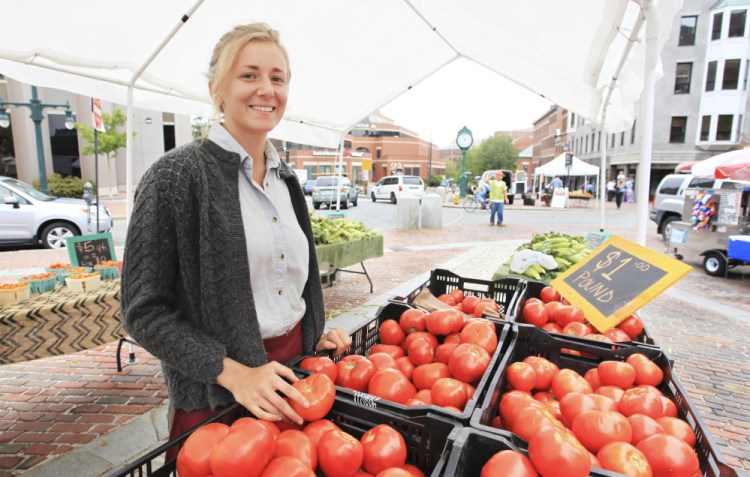 Grace Pease of Merrifield Farm in Cornish with fresh tomatoes from her farm selling for $1 a pound at the Portland Farmers' Market.