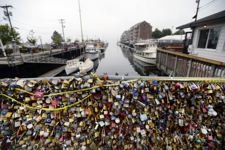 The Love Locks fence in Portland is weighed down with expressions of love and loyalty Thursday. After it's removed, a large portion of the fence, with the locks intact, will be displayed in a nearby parking lot.