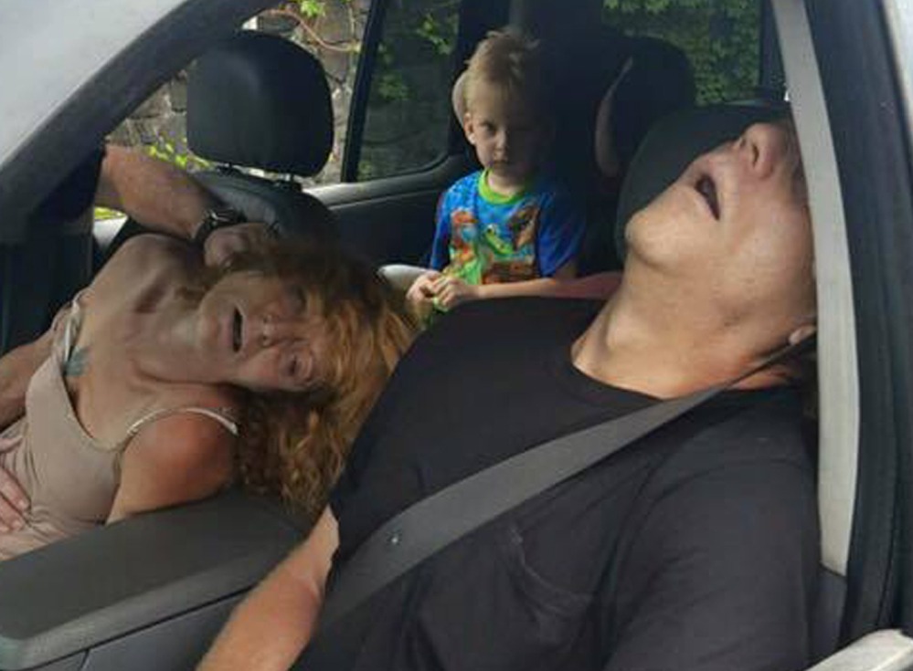 A boy witnesses a woman unconscious and turning blue alongside another overdosing adult in a car East Liverpool, Ohio, on Wednesday. The city's director of public service and safety called the photo "the truth" about the addiction crisis.
