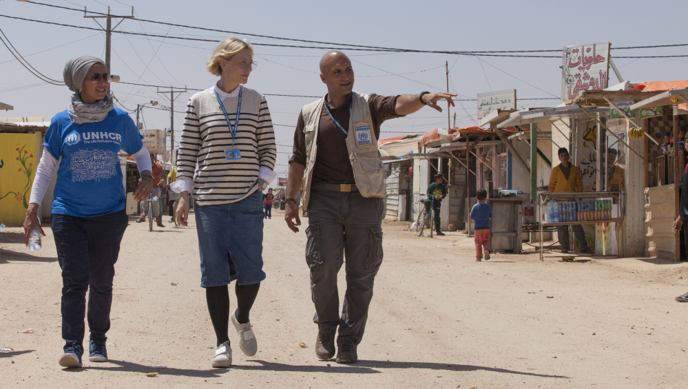 Cate Blanchett, center, and camp manager Hovig Etyemezian, right, walk through the Zaatari camp in Jordan, which houses Syrian refugees. Blanchett and other movie stars address the plight of refugees in a stark, short video.