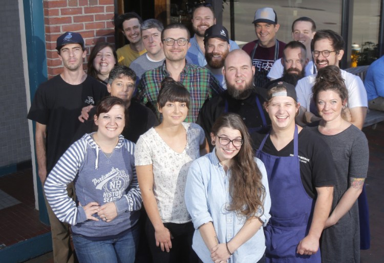 Restaurateur Mike Wiley, in center wearing glasses, with some of his crew from Hugo's, Eventide and The Honey Paw.