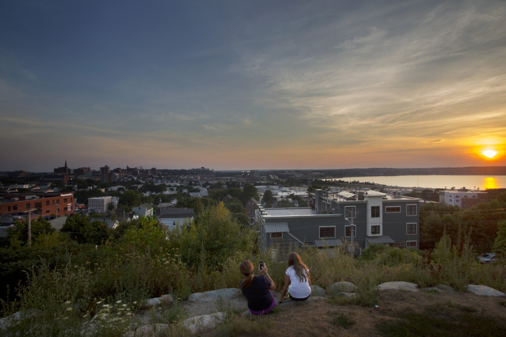 Nicole Hoglund of Portland, left, enjoys the sunset with her niece Sophia Lanzano of New Jersey last month from Fort Sumner Park, a public space on Portland's Munjoy Hill.