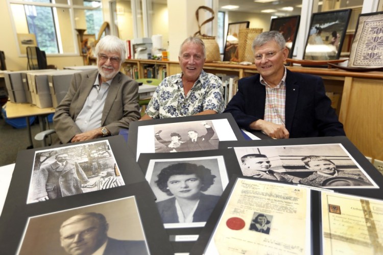 Keene, N.H., State College professors, from left, Lawrence Benaquist, Tom Durnford and Paul Vincent, sit behind photos that they used to research a Massachusetts couple who helped Jewish refugees flee the Nazis during World War II.