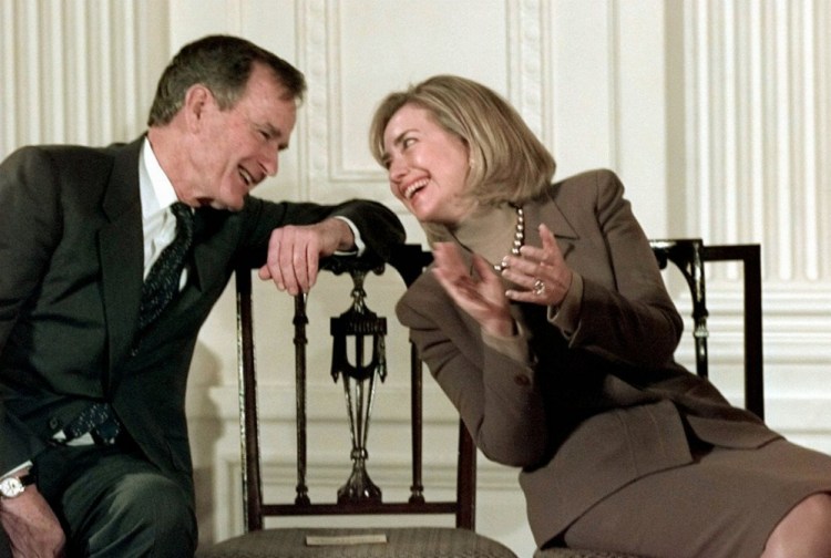Former President George H.W. Bush and then-first lady Hillary Clinton converse at the White House in 1997. CNN reported that Bush told about 40 people meeting Monday in Kennebunkport that she will get his vote.