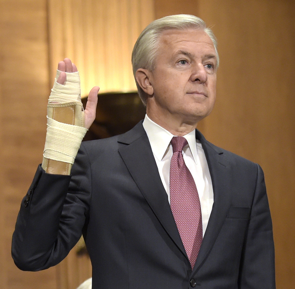 With Sen. Elizabeth Warren calling for his resignation, John Stumpf raises his right hand that, according to CNBC, he claimed to injure while playing with his grandchildren.