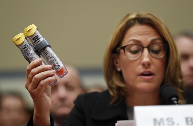 Mylan CEO Heather Bresch holds up an EpiPen while testifying on Capitol Hill in Washington on  before the House Oversight Committee hearing on EpiPen price increases. Bresch defended the cost for life-saving EpiPens, signaling the company has no plans to lower prices despite a public outcry and questions from skeptical lawmakers.
