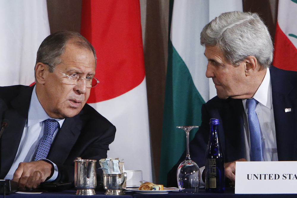 Russian Foreign Minister Sergey Lavrov and United States Secretary of State John Kerry talk during a meeting of the International Syria Support Group on Thursday in New York.