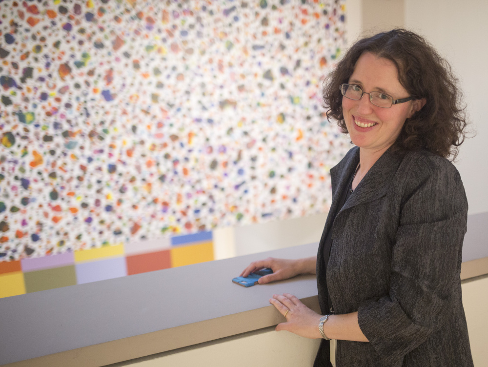 Jessica May, chief curator at the Portland Museum of Art, in front of A Midsummer Night's Dream, 2016, ink on latex saturated cellulose, by Tim Rollins and the K.O.S. (Kids of Survival). The work was recently acquired for the museum's permanent collection. The Tim Rollins and the K.O.S. exhibit is a survey of the groupÕs work in a variety of media and will be on display till December 31. Rollins was born and raised in Pittsfield, Maine.