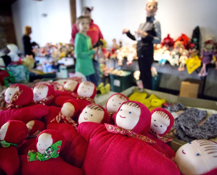 Dolls donated by Bertha Chasse are popular items during a sale at Museum L-A in Lewiston on Saturday, as were nostalgic items like coat hooks from a former school.