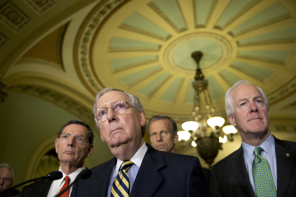 Senate Majority Leader Mitch McConnell of Ky., accompanied by, from left, Sen. John Barrasso, R-Wyo., Sen. John Thune, R-S.D., and Senate Majority Whip John Cornyn of Texas, listen to a question during a news conference on Capitol Hill in Washington. Democrats hope that Republicans will relent and provide money to help Flint, Mich., with its water crisis – and get Capitol Hill off a collision course that could lead to a government shutdown this weekend.