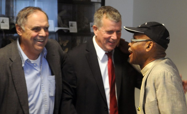 The Rev. Steven Craft, right, greets Hal Shurtleff, center, director of New Hampshire's Camp Constitution, and Paul Madore, a conservative activist, before a news conference Wednesday in Augusta to discuss remarks that Gov. Paul LePage made regarding the race of people charged with drug crimes.