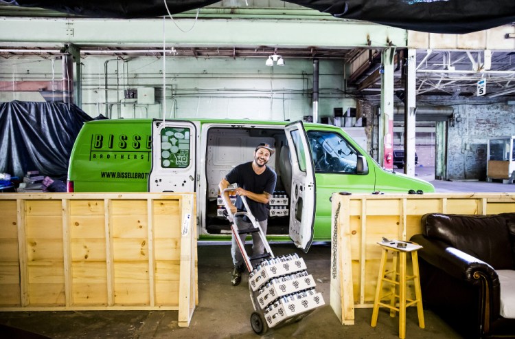 Josh Schlesinger, owner of Sleek Machine Distro, loads his distribution van last month with Bissell Brothers beer for delivery to Ohno Cafe and the Bier Cellar on Forest Avenue in Portland. His one client, which opened in 2013, is one of the hottest brewers in Maine. "On a marketplace end, it's my baby. I am deeply devoted to this beer," he said.
