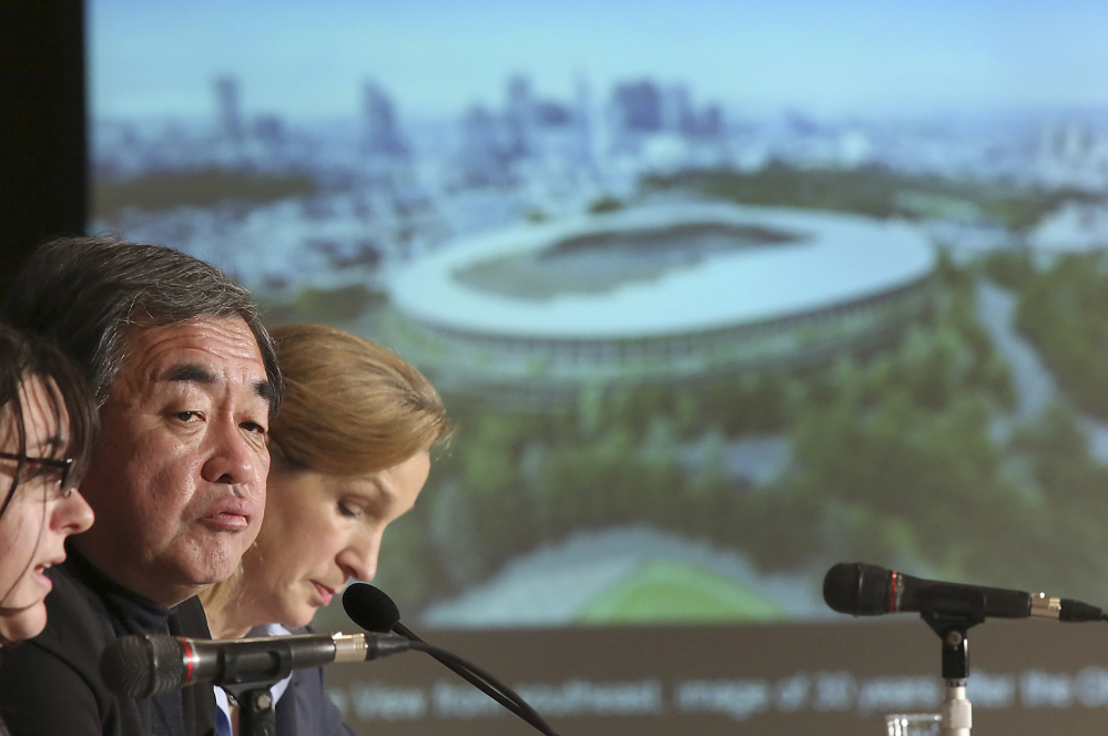 Japanese architect Kengo Kuma, second left, speaks about his design of the 2020 Tokyo Olympic stadium during January a press conference in Tokyo. A Tokyo government panel is set to propose moving more venues outside of the city — including hundreds of kilometers (miles) away — in order to save money, the latest in a series of changes since the Japanese capital was awarded the games three years ago.