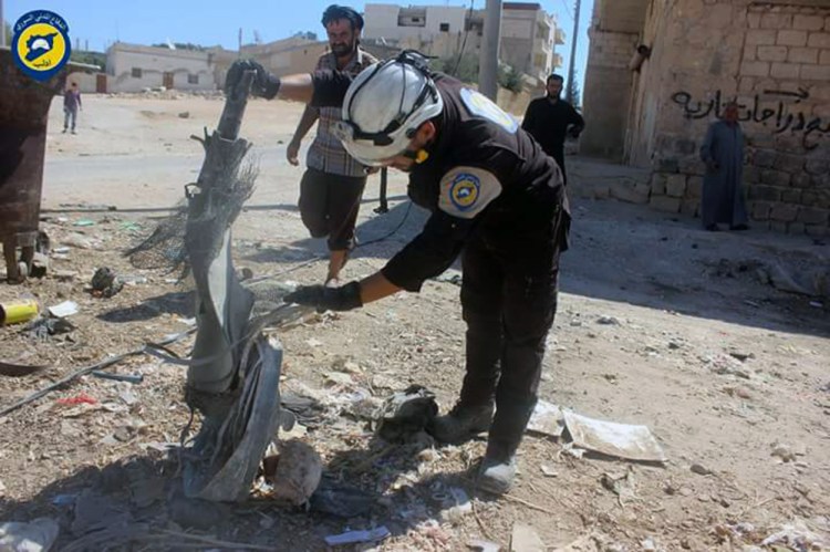 Members of Syrian Civil Defense inspect cluster bombs in the Khan Sheikhoun neighborhood of Idlib, Syria, on Thursday.