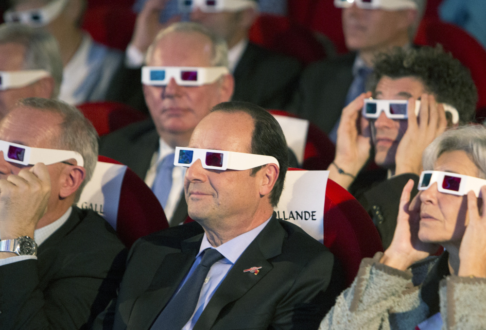 French President Francois Hollande, center, and others wear 3D glasses at a mission broadcast in Paris in 2014. It was a historic first when the Rosetta's lander touched down on comet 67P after a decade-long journey through space.