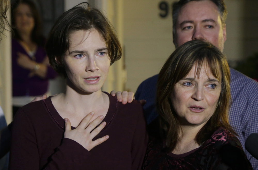 Amanda Knox, left, stands with her mother, Edda Mellas, as she talks to media in Seattle in 2015. Knox spent four years in jail before her conviction was overturned. Associated Press/ Ted S. Warren