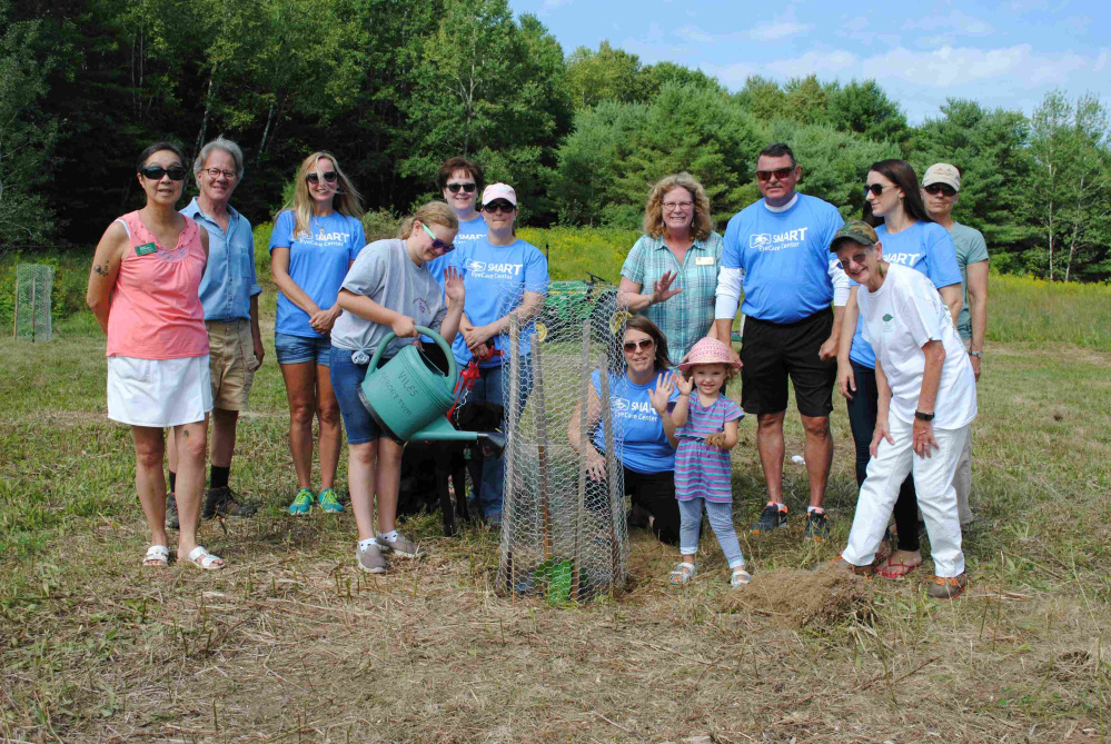 Twenty volunteers, mostly from Smart Eye Care, teamed up with board members of the Viles Arboretum and Lisa Thompson, executive director of The American Chestnut Foundation, Aug. 6 to plant the first five trees of the newly bred resistant variety of the American Chestnut. Back, from left, are Sammee Quong, Dean Corner, Sandi Sleeper, Dee Perrault, Shawna Stewart, Lisa Thompson, Paul Wheeler, Carrie Howe and Hillary Schultz. Front, from left, Kali Stewart, watering the tree, with Jen Lizzotte and Abby Cormier.