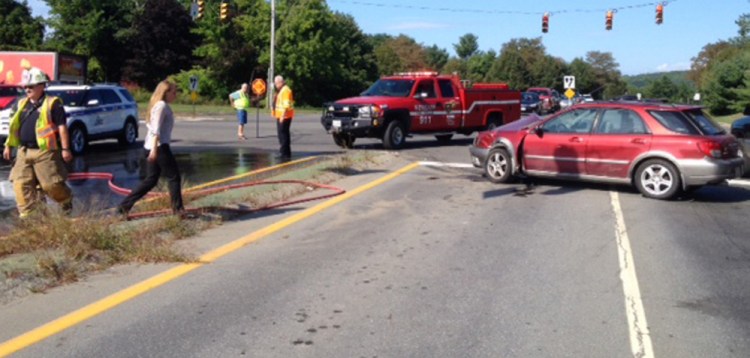 Emergency responders work at the scene of a car crash Thursday morning where a driver of a 2002 Subaru Impreza T-boned a 2008 Ford Fusion, whose driver proceeded through a red light at the intersection of Carter Memorial Drive and Augusta Road in Winslow.