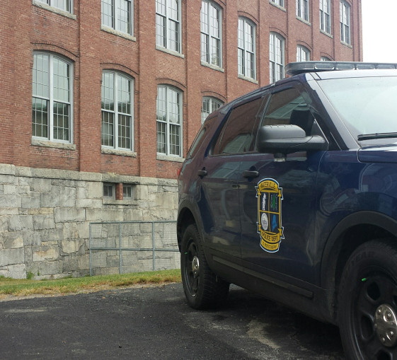 A Waterville Police cruiser is stationed in the parking lot at the Hathaway Creative Center Tuesday as a body is recovered from the Kennebec River.