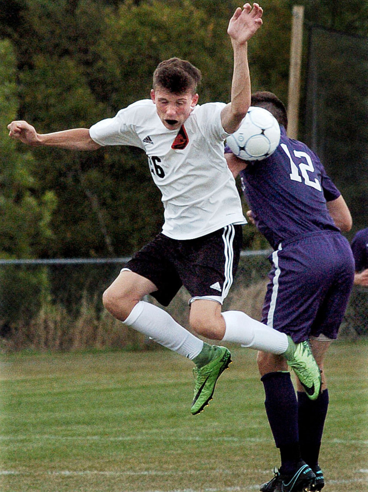 Winslow's Daylon Carpenter, left, and Waterville's Justin Wentworth go up for the ball Tuesday in Winslow.