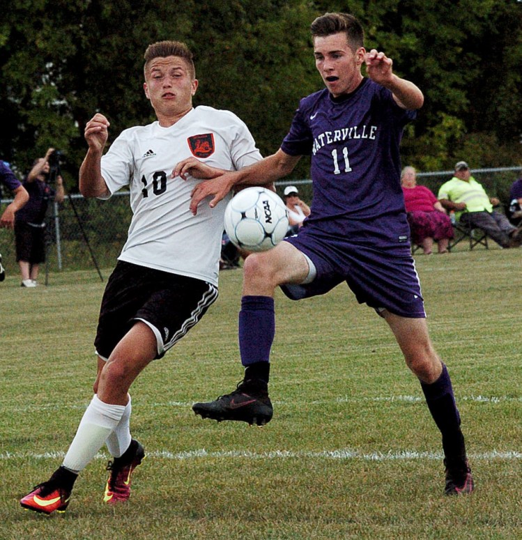 Winslow's Michael Wildes, left, and Waterville's Ethan Cayer go after the ball during a game Tuesday in Winslow.