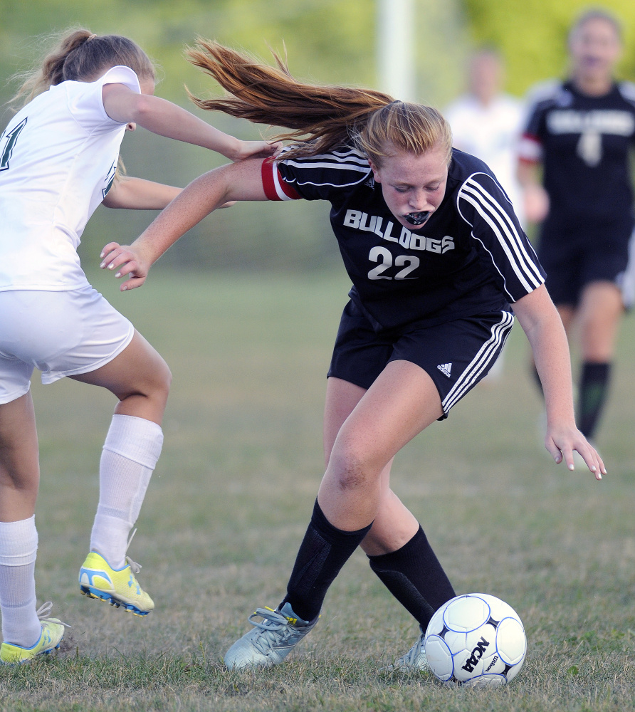 Winthrop's Danielle McClure, left, pushes off Hall-Dale's Sabrina Freeman during a game Tuesday in Winthrop.