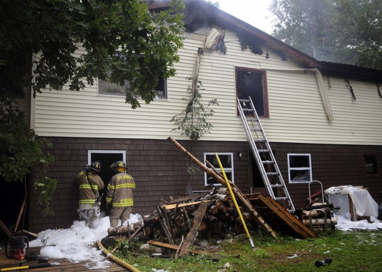 Firefighters extinguish a blaze that heavily damaged a Mount Vernon home early Wednesday morning.