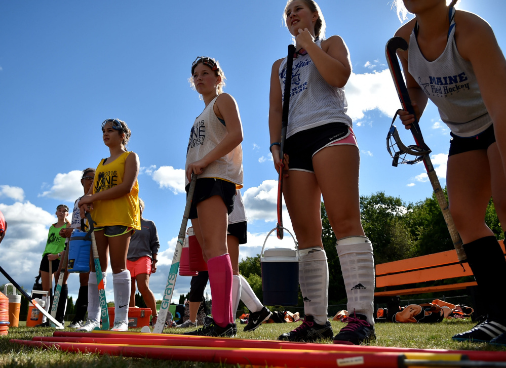 The Winslow High School field hockey team takes a quick break during an Aug. 17 practice at the high school.