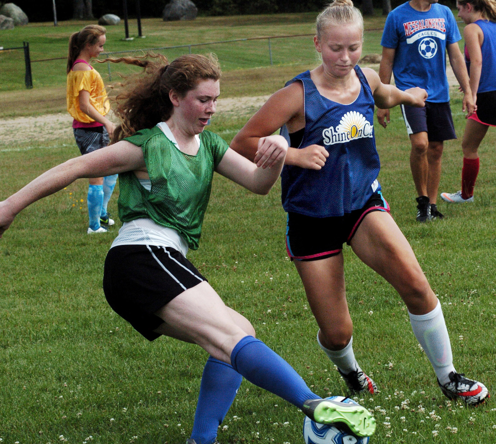 Messalonskee soccer players Ella Moore, left, and Fern Calkins compete during practice on Aug. 15 in Oakland.